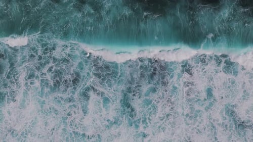Aerial Topdown View of Ocean Waves Crashing on Bali's Shoreline