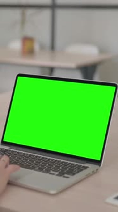 Young Woman Working on Laptop with Green Chroma Screen, Vertical Video