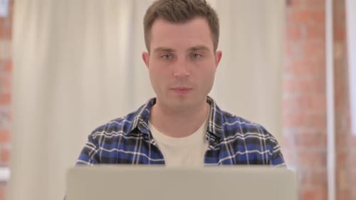 Close up of Young Man Working on Laptop