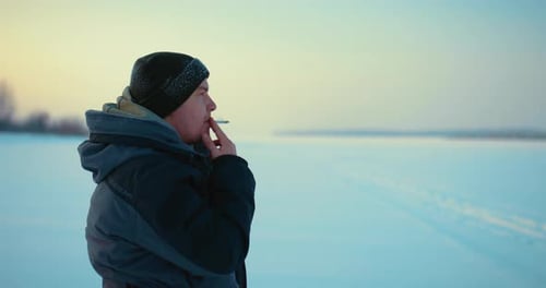 Fisher or Hiker Smoking Cigarette on Frozen River Profile Portrait in Winter Morning Prores