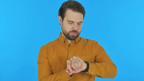 Man using Smartwatch on Blue Background, Portrait