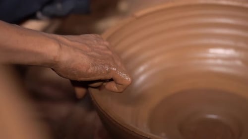 Hands Shaping Clay on Pottery Wheel