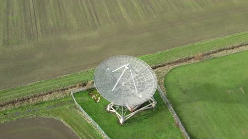 Aerial View of Satellite Dish in Green Field