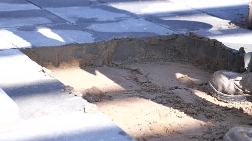 Workers Take Stones with Shovel to Put Into Pit on Road