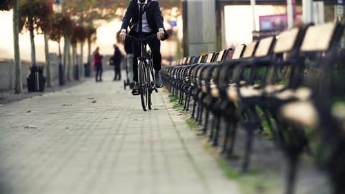 Midsection Of Businessman Commuter Traveling Home From Work In City On A Bicycle.