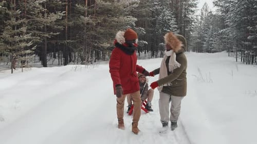 Family Enjoying Snowy Winter Day