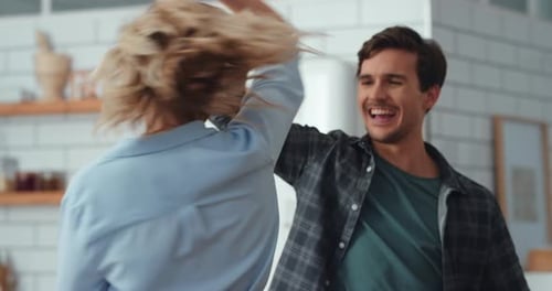 Happy Couple Dancing and Laughing in Kitchen