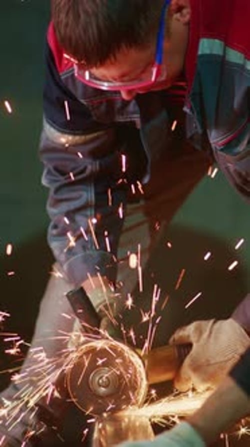 Man Working with Grinder Tool in Workshop Indoors