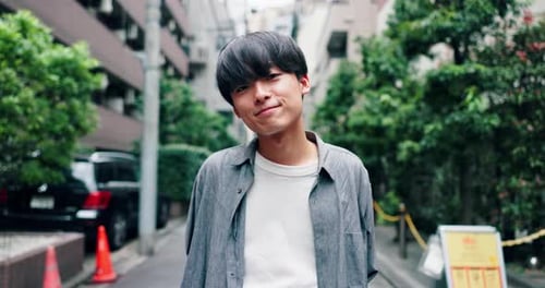 Travel, happy and face of Asian man in city with smile for holiday, adventure and weekend outdoors