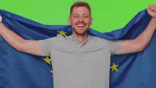 Man Holds European Union Flag Against Green Screen