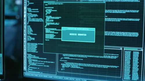Hackers Working at Computers Exploiting Security Vulnerability