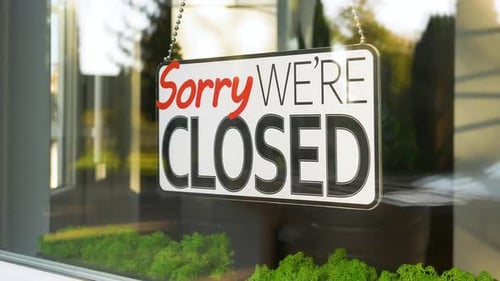 Sorry, We're Closed Sign in Storefront Window