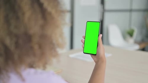 Young African Woman Watching Smartphone with Chroma Key
