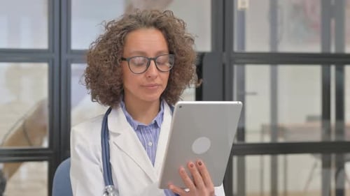 Woman Doctor Working with Tablet in Office Setting