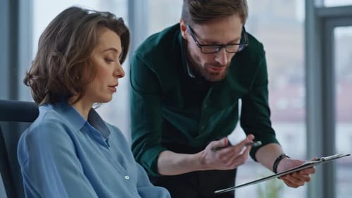 Business Colleagues Discussing Data in Modern Office