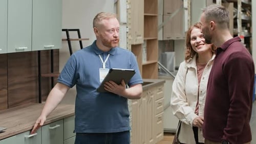 Shop Assistant Communicating with Couple