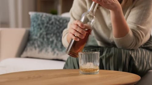 Woman Pours Drink in Home Interior