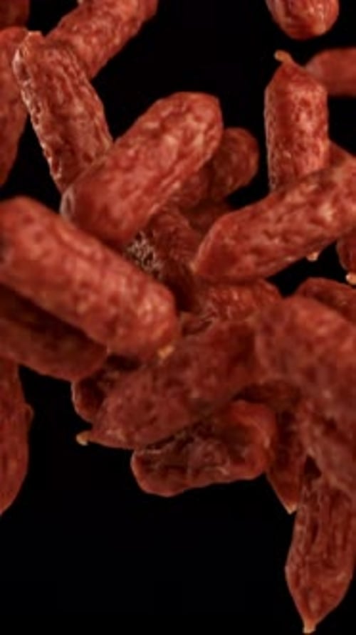 Mini Salami Fly and Fall on a Black Background Filmed on a Highspeed Camera at 1000 Fps