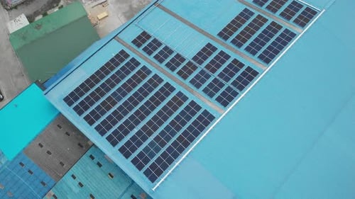 Aerial view of solar cell panels installed on roof of the factory.