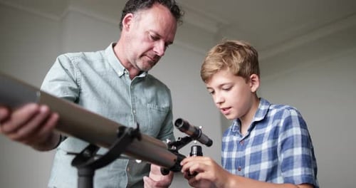 Father teaching Son how to use a telecsope