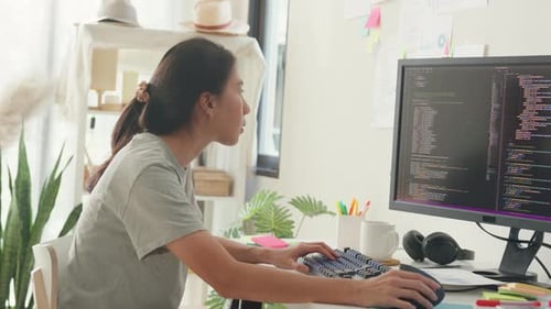 Asia girl IT development programmer typing on keyboard coding programming fixing data code.