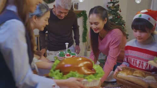 Family Celebrates Christmas Dinner Together at Home