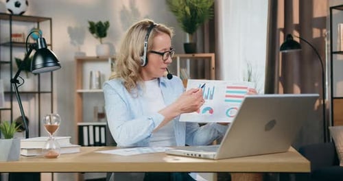 Woman Presenting Financial Data in a Video Conference