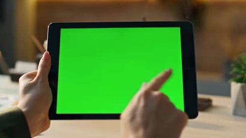 Tablet with green screen being used indoors