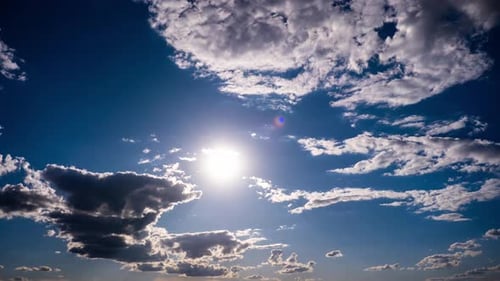 Timelapse of Cumulus Clouds Moving In The Blue Sky Against The Sun