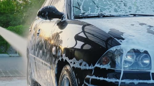 Washing Luxury Black Car on Touchless Car Wash Cleaning the Details of Car Washing Sedan Car with