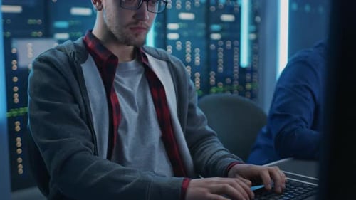 Young Men Working in Data Center at Night