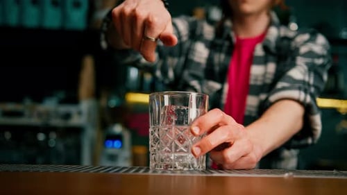 Ice Cubes Placed Into Glass by Bartender