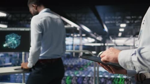Close Up of Data Center Software Developer Doing Maintenance Tasks on Tablet