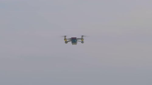 A view of a quad-copter taking off at the beach.