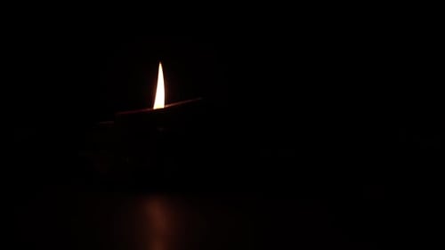 Diya Oil Lamp Flame Flickering in Darkness