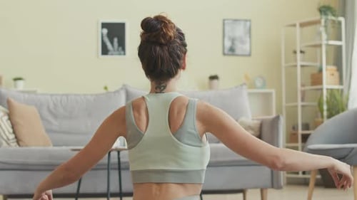 Woman Meditating at Home Back View