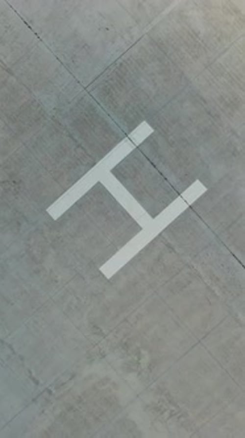 Helicopter landing site. Aerial view of a large modern industrial factory. Vertical video