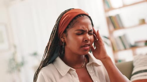 Stress, headache and student with woman on sofa for college debt, vertigo pain and mental health