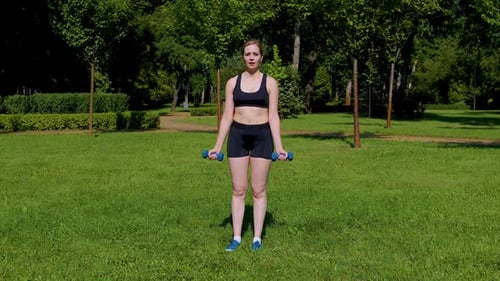 Woman Doing Bicep Curls in Green Park