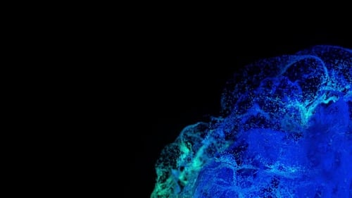Vibrant Blue and Green Particles Explode in Darkness