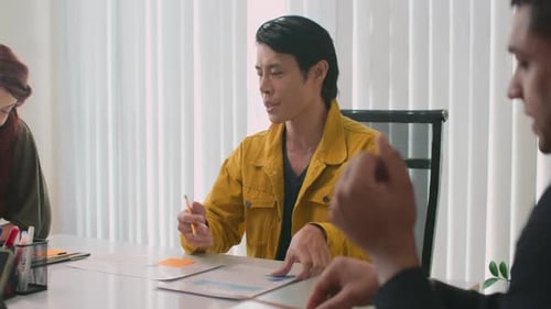 Adults Meet in Bright Office to Discuss Graphs