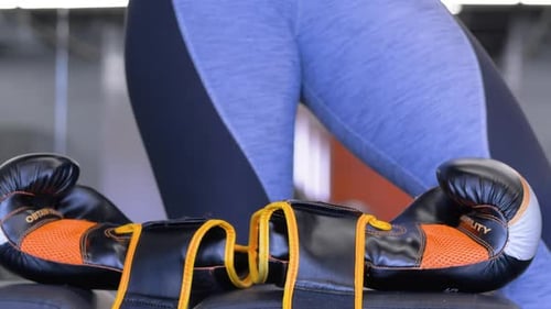 Black and Orange Boxing Gloves on Gym Bench