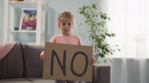 Tired Sad Resentful Little Girl Stands and Holds Poster