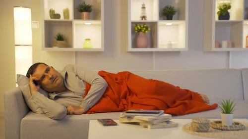 Man lying in bed depressed.