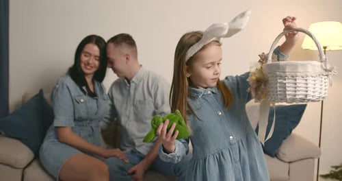 Parents and Little Daughter Celebrating Easter at Home