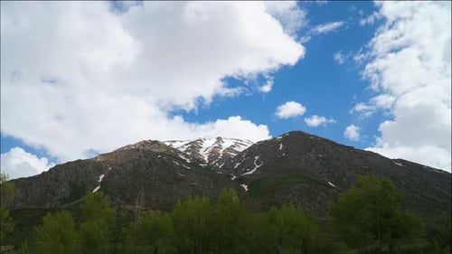 Majestic Mountains Under Blue Sky and Clouds
