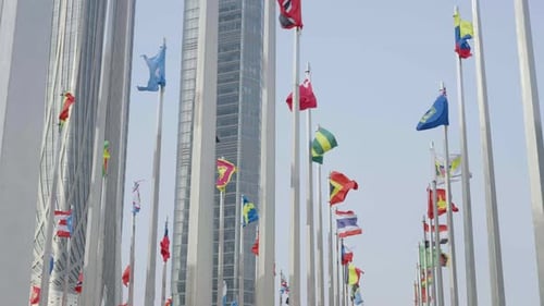 International Flags Waving in Modern City Setting