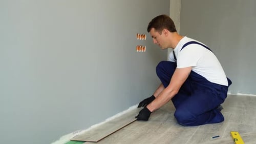 Man Installs Wood Floor in a Home