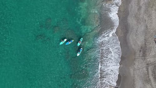 Aerial View Paddleboard Festival in the Bay As People Play and Relax