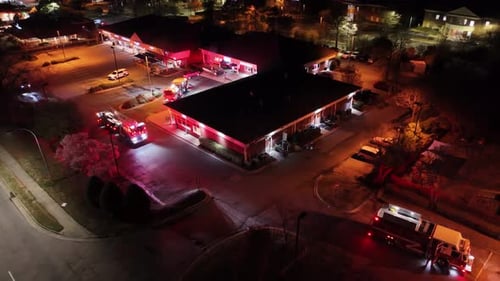 Aerial View of Fire Trucks Responding to an Emergency Call at Night